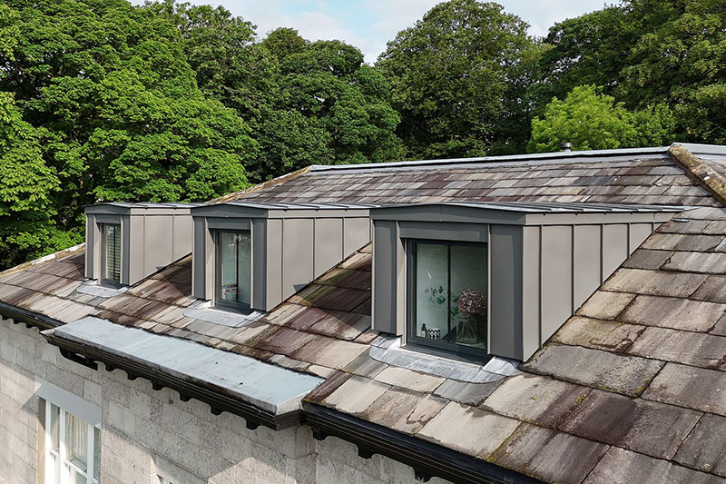 Hard metal zinc cladding fitted to dormers with slate roofing by KingCraft roofing & cladding specialists in Leeds, West Yorkshire.