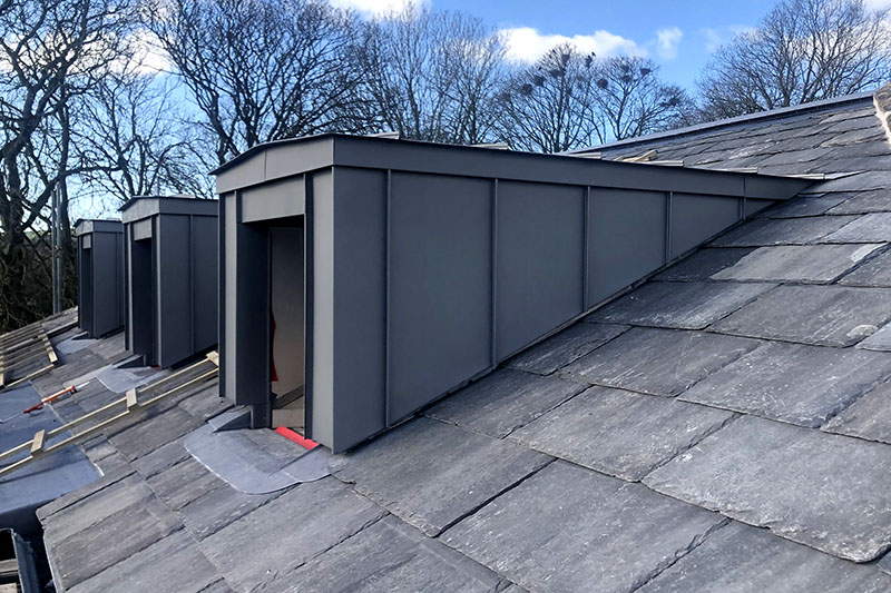 Standing seam zinc cladding system integrated with slate roofing by KingCraft, local roofing & cladding contractor in Leeds.