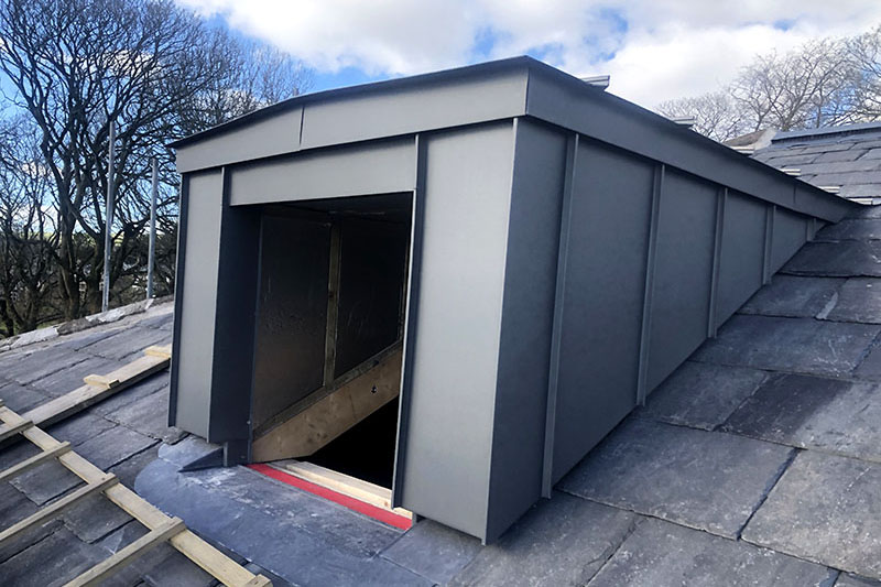 Zinc panels on wall cladding system and slate roofing installed by KingCraft - Leeds-based roofing & cladding contractor, Yorkshire.