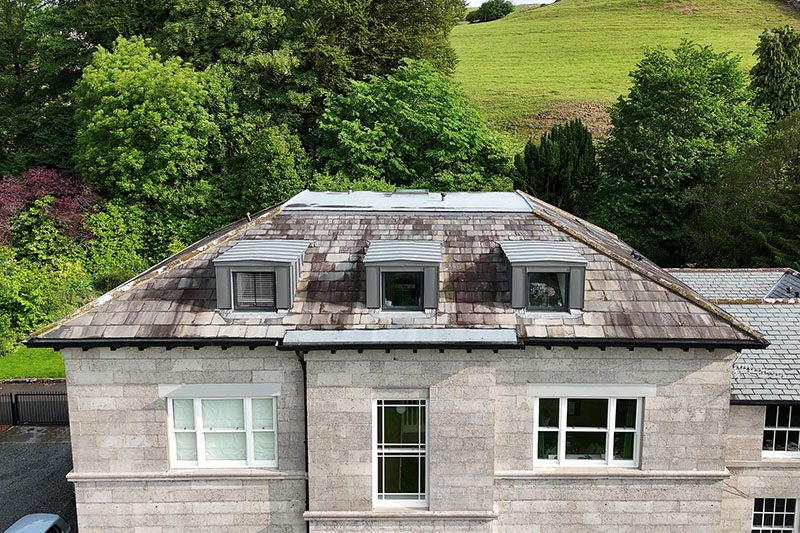 Standing seam zinc wall panels installed on cold roof with natural slates by KingCraft roofing & cladding, Leeds, Yorkshire.